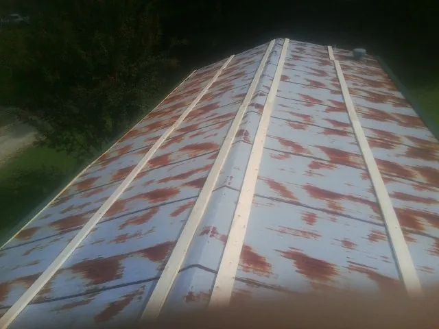Rusted metal roof panels with new wood purlins before replacement — Storm Damage Roof Repair in Gravel Switch by Roofing Brothers